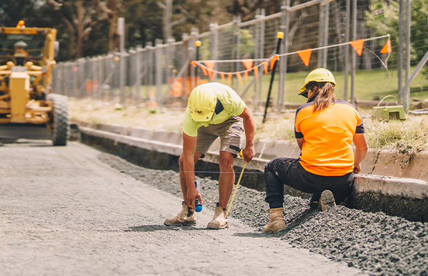 Construction workers working on road together