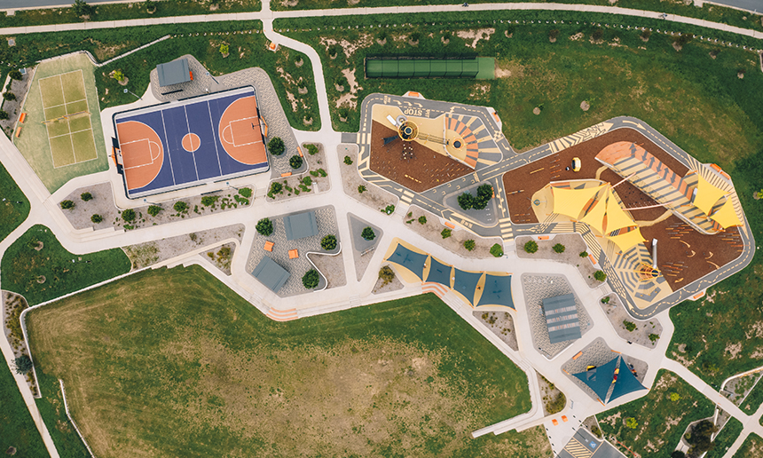 Drone image bird's eye view of colourful, modern playground and landscaping.